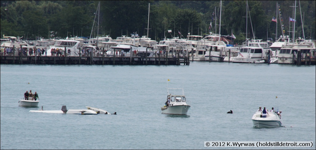 Three divers accompany the drifting hull